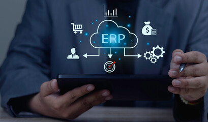 Fototapeta premium ERP, Enterprise Resource Planning concept. Businessman holding virtual cloud icon connecting data to HR management, finance, and sales for company resource planning.