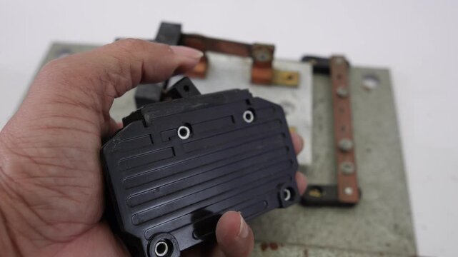 Hand handling old circuit breakers and electrical busbars
