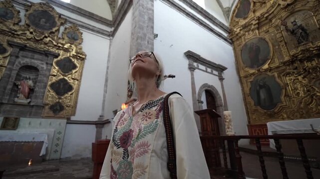 Mature woman enjoys her time exploring the Mission San Ignacio in Baja California Sur while appreciating the architecture and history.