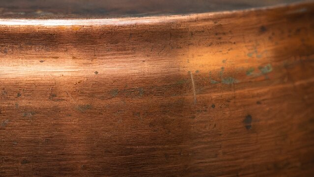 abrasion. Close-up of brushed copper texture with visible patina and directional lighting. safety posters, maintenance manuals, designed for industrial assembly lines and welding operations.