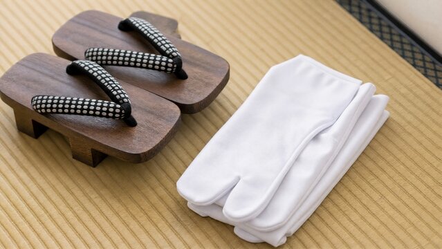 tabi. New Japanese tabi socks and geta sandals arranged on a tatami mat. lifestyle magazines, social media lookbooks, designed for lifestyle magazines and social media content, used by videographers.