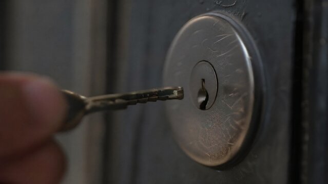 misaligned. A metal key slightly misaligned with a door lock's keyhole in dim light. product launch decks, UI/UX mockups, designed for data visualization dashboards and holographic UIs.