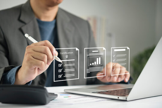 Businessman using laptop with digital certification document approval compliance audit checklist