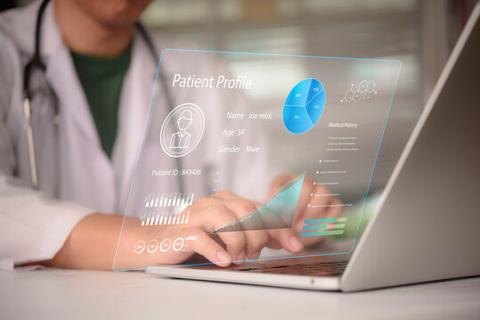Doctor analyzing electronic health record EHR hologram interface on laptop