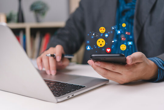 Hand touching smartphone screen virtual hologram like heart emojis overlay social media management dashboard influencer marketing.