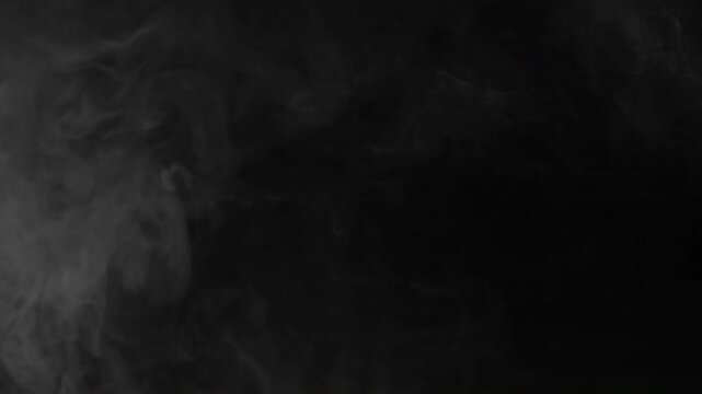 Realistic White Smoke Drifting Slowly Across A Dark Black Background.
