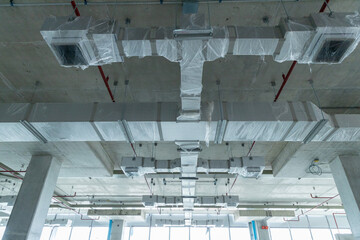 Naklejka premium HVAC air ducts installation on building ceiling