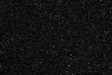 Fototapeta premium Black foam sponge material with iridescent highlights, similar to space