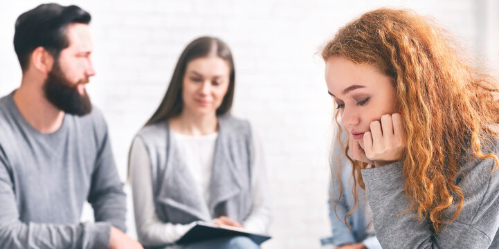 Awareness of addiction. Depressed pensive woman sitting at rehab group therapy, panorama with free space