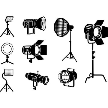 Collection of various studio lighting equipment and photography softbox reflectors on stands for professional photo shoots.