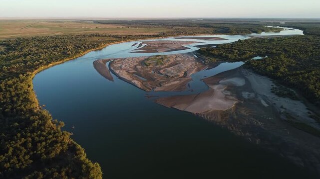  Panoramic aerial view of winding Syr Darya river with sandy islands and forest valley at sunset, Kazakhstan. High quality 4k footage