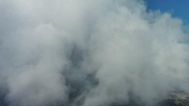Aerial high around view of clouds and blue sky, flying in clouds, 4k