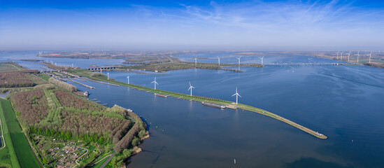 Wide panoramic aerial view of the Volkerakdam dyke with wind turbines, A29 motorway bridge and...