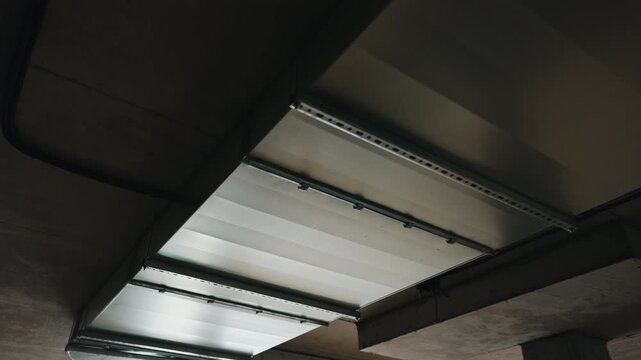 Industrial ventilation ducts mounted on ceiling inside parking structure