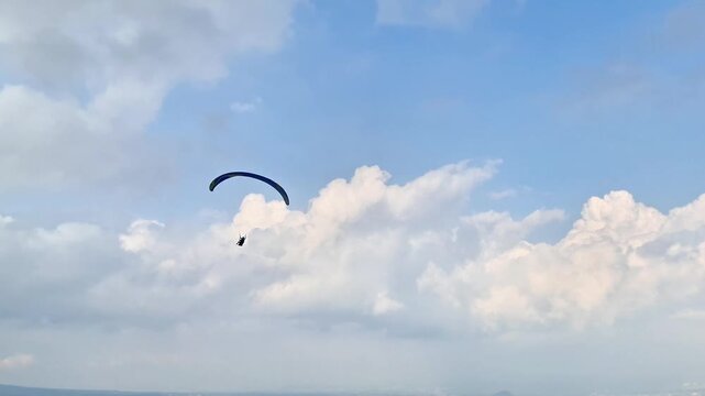 Malang, Indonesia - 3 May, 2026: Beautiful Aerial Panorama of Paragliders Flying Above Batu City and Rice Terraces