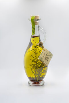 Gourmet Olio di Oliva glass bottle with rosemary and spices.