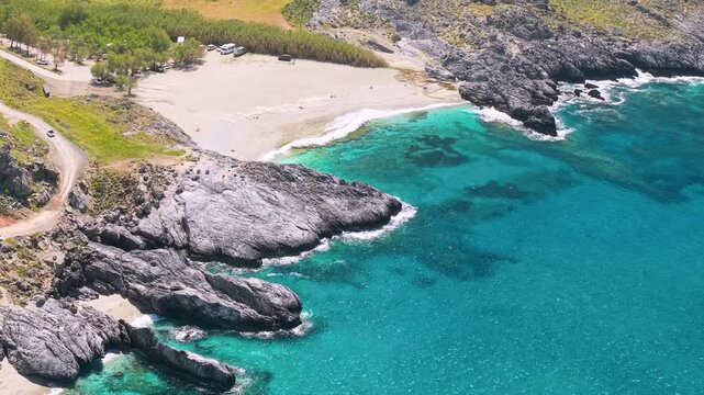 Klisidi rocks trident and Damnoni beach Crete Greece aerial top down view, drone flight from hidden coves to turquoise sandy bay, Mediterranean sea coastal geometry panoramic travel video
