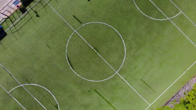 Overhead view of a football field with a spinning zoom in
