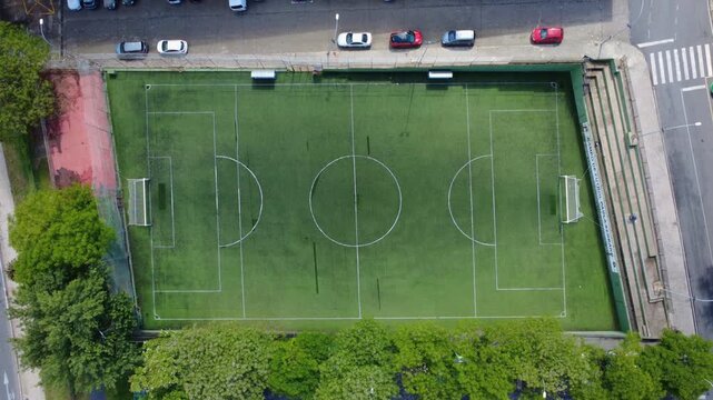 Overhead wide shot of a football field with a smooth zoom in