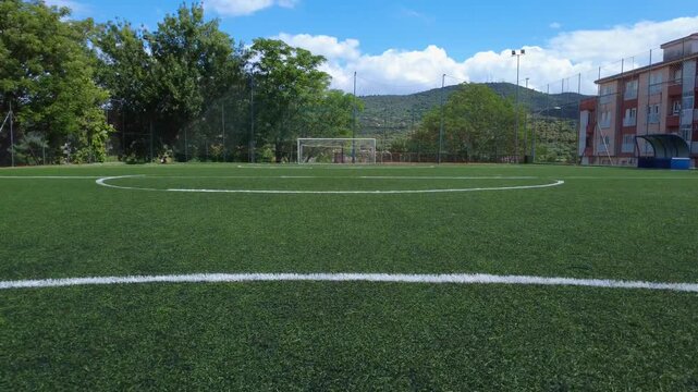 Aerial drone shot of a football field with forward movement