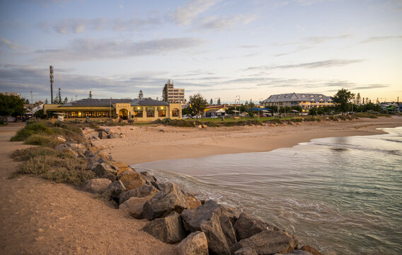 Dome cafe and rock breakwater at City Beach at sunset, Geraldton, Western Australia, 28 February 2023