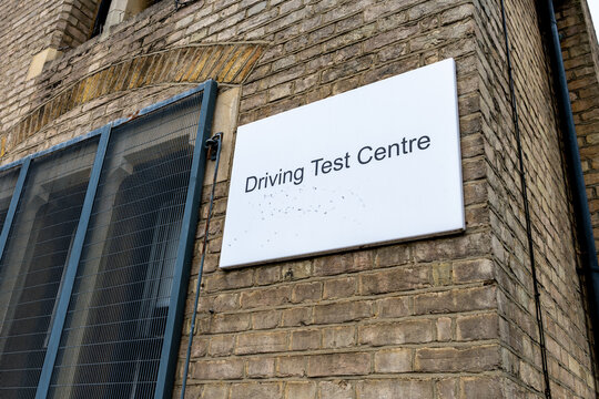 A Driving Test Centre sign on the facade of a building.