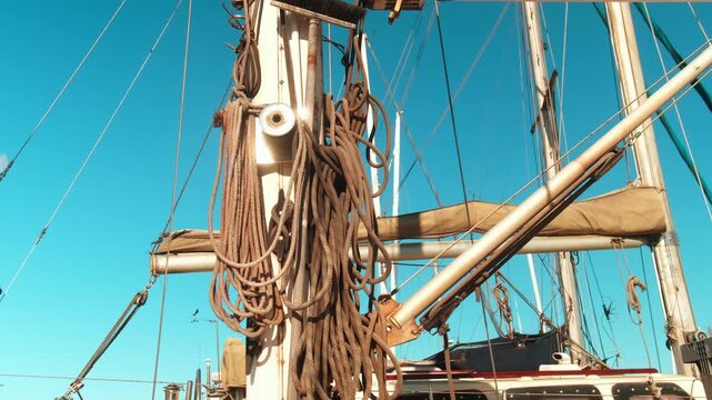 Close-up of sailboat mast and rigging against clear blue sky, highlighting nautical engineering, sailing equipment and maritime adventure lifestyle themes.