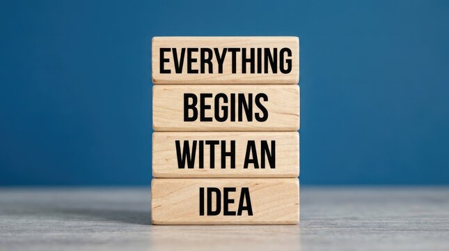 Wooden blocks with motivational quote everything begins with an idea