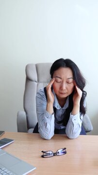 Extremely tired exhausted business woman taking off eyeglasses feeling headache and dizziness, vision problems, eyes strain, overworking on laptop or pc, hot flush during periods, health problems
