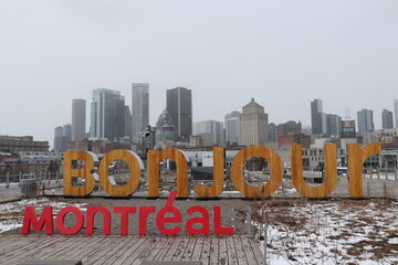 Bonjour Montreal Sign With City Skyline Background On Winter Day © Elías