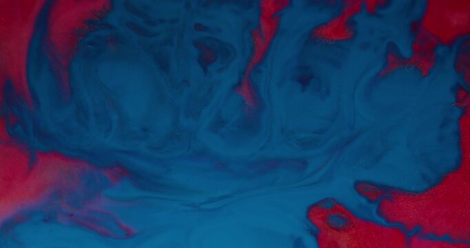 Paint splash. Color blend. Defocused red blue glitter texture spatter liquid floating on abstract acrylic creative art background.