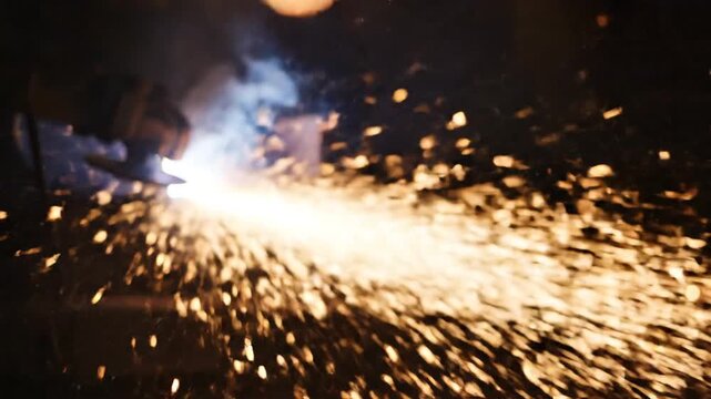 Bright industrial sparks and smoke from welding process