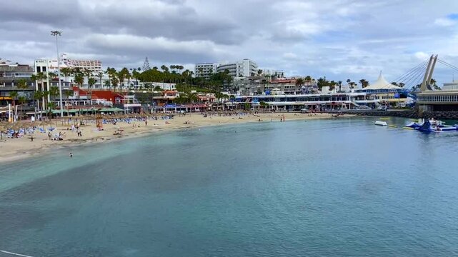 View of Playa La Pinta in Puerto Colon, Tenerife,
Canary Islands, Spain. It is a small beach with volcanic sand, calm waves and transparent water,4K