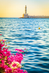 Fototapeta premium bay of Chania with sea and lighthouse at sunny summer sunset, Crete, Greece, web banner format