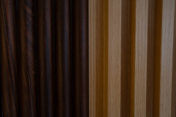 Obraz premium Close up of vertical wooden slats featuring a contrast between dark walnut and light oak wood grain finishes