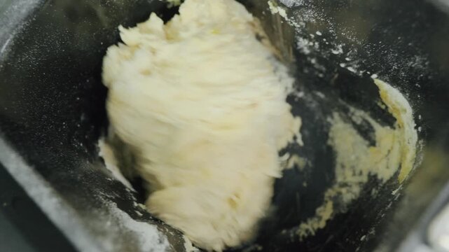 Homemade bread preparation: kneading dough in machine