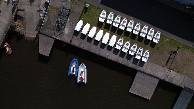 Top Down Aerial View of Rows of Small White Sailing Boats at a Pier