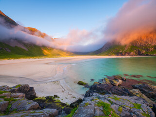 Norwegian arctic fjord at midnight sun. Lofoten Islands, Norway. Arctic landscape with mountains, ocean and golden clouds. Scenic Nordic nature with summer night light and mountain peaks. © biletskiyevgeniy