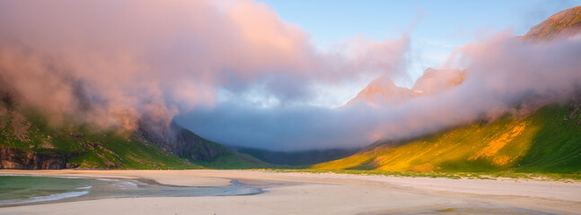 Norwegian arctic fjord at midnight sun. Lofoten Islands, Norway. Arctic landscape with mountains, ocean and golden clouds. Scenic Nordic nature with summer night light and mountain peaks. © biletskiyevgeniy