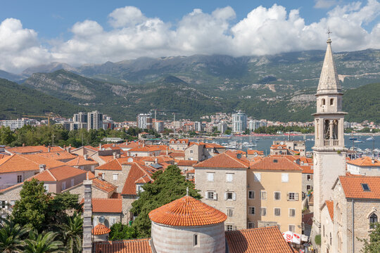 Elevated view over Budva Old Town and the Citadel with red tiled roofs, stone buildings and church bell tower, overlooking the Adriatic coast in Montenegro