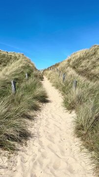 path in the sand dunes to the sea 