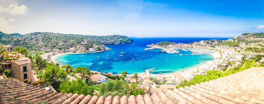 view of Port Soller harbour with house roofs, Mallorca at summer, wide panorama
