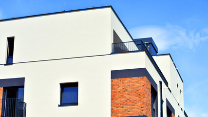 Obraz premium Contemporary apartment building in city. Residential building with balconies and modern facade.