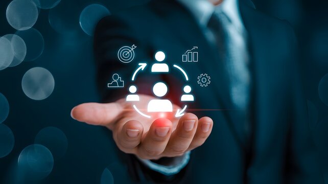 Strategic Business Management and Human Resource Development Concept Professional hand presenting interconnected digital icons for teamwork, talent acquisition, and organizational growth