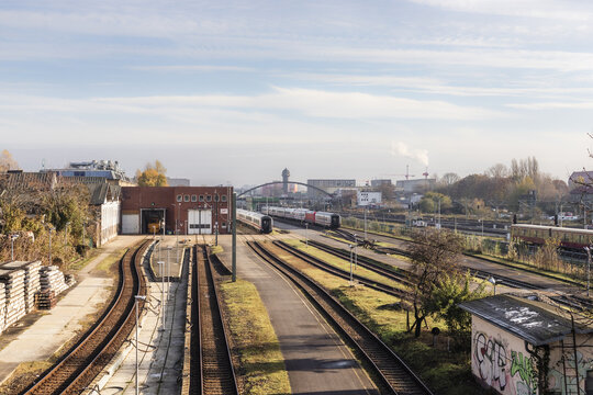 Berlin, Germany - 23 November 2022: View of the railway tracks and industrial buildings at the Berlin-Lichtenberg station area with trains parked under a soft morning light.