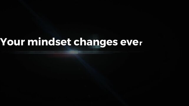 Motivational text animation your mindset changes everything with glowing blue lens flare effect displayed against a deep dark black background for cinematic impact