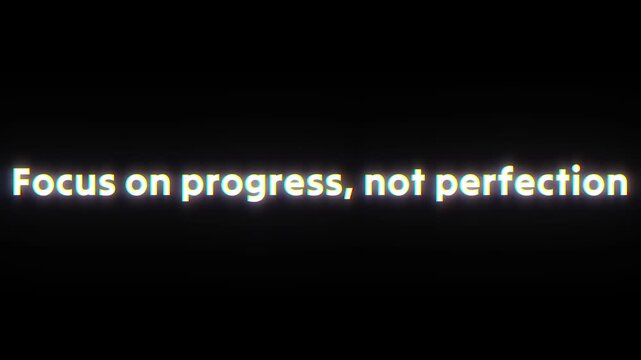 Focus on progress not perfection motivational quote text animation featuring glowing white typography against a minimalist solid black background for creative projects