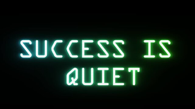 Glowing neon sign with motivational quote 'success is quiet' on black background