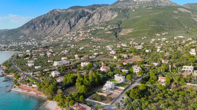 Aerial Drone View of Mikri Mantineia Near Kalamata With Mountain Slopes, Seaside Villas, Olive Groves, Coastal Road and Blue Mediterranean Sea in Greece