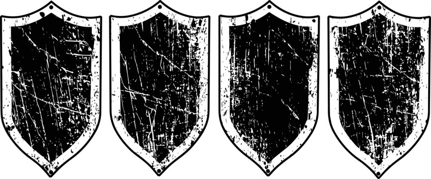Set of four vintage distressed shield shapes with textured scratches and grunge effects